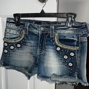 A NWNTMissMe pair of shorts with flowers.